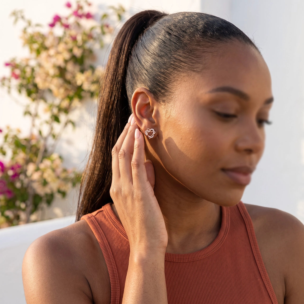 Rose gold heart earrings — worn, everyday gesture, rose gold | SKU: 419593-rose-gold