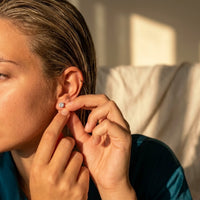 Thumbnail for Solitaire Crystal Studs in Gold, being put on | SKU: 41010-gold