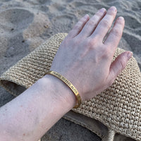Thumbnail for Travel To Feel Alive bracelet in gold worn, showing its real size | SKU: ttfa-g