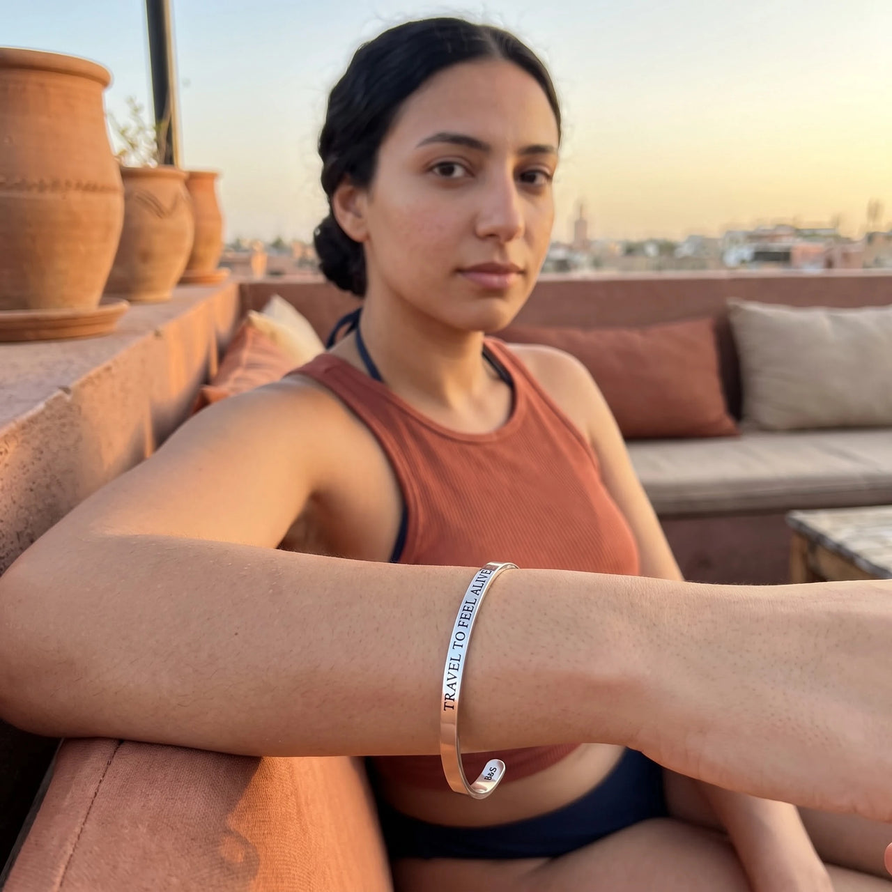 Travel To Feel Alive bracelet in silver worn during a relaxed moment | SKU: ttfa-wg